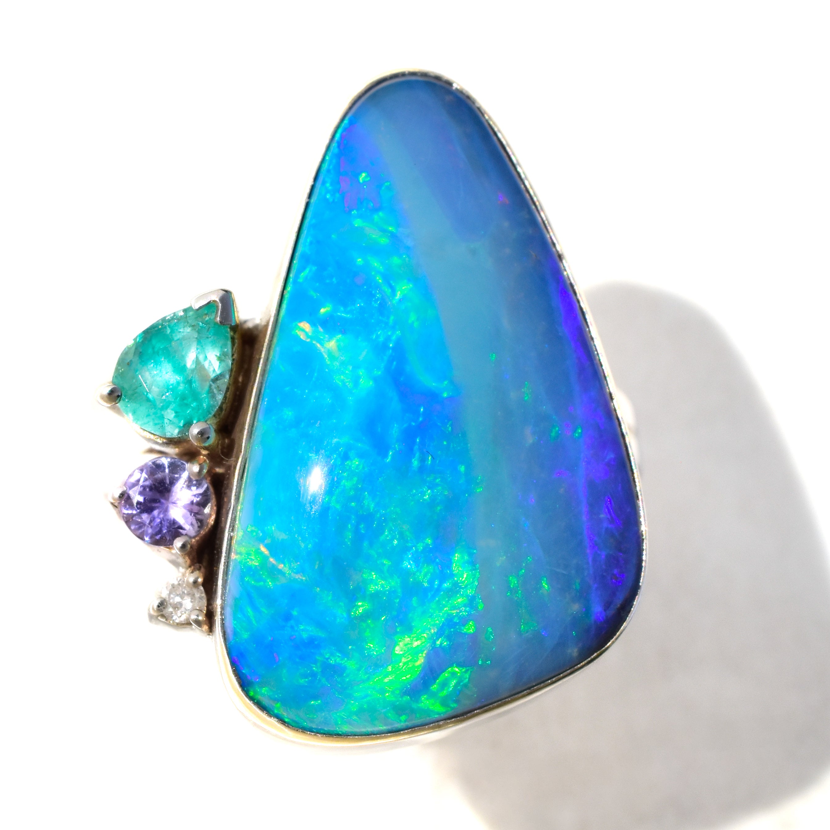 Asymmetrical Australian Boulder Opal Statement Ring paired with Emerald, Tanzanite and a Diamond Accent in Solid 14k White Gold